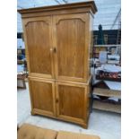 AN OAK CABINET WITH TWO LOWER AND TWO UPPER DOORS