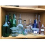 A COLLECTION OF VARIOUS GLASS BOTTLES AND JARS