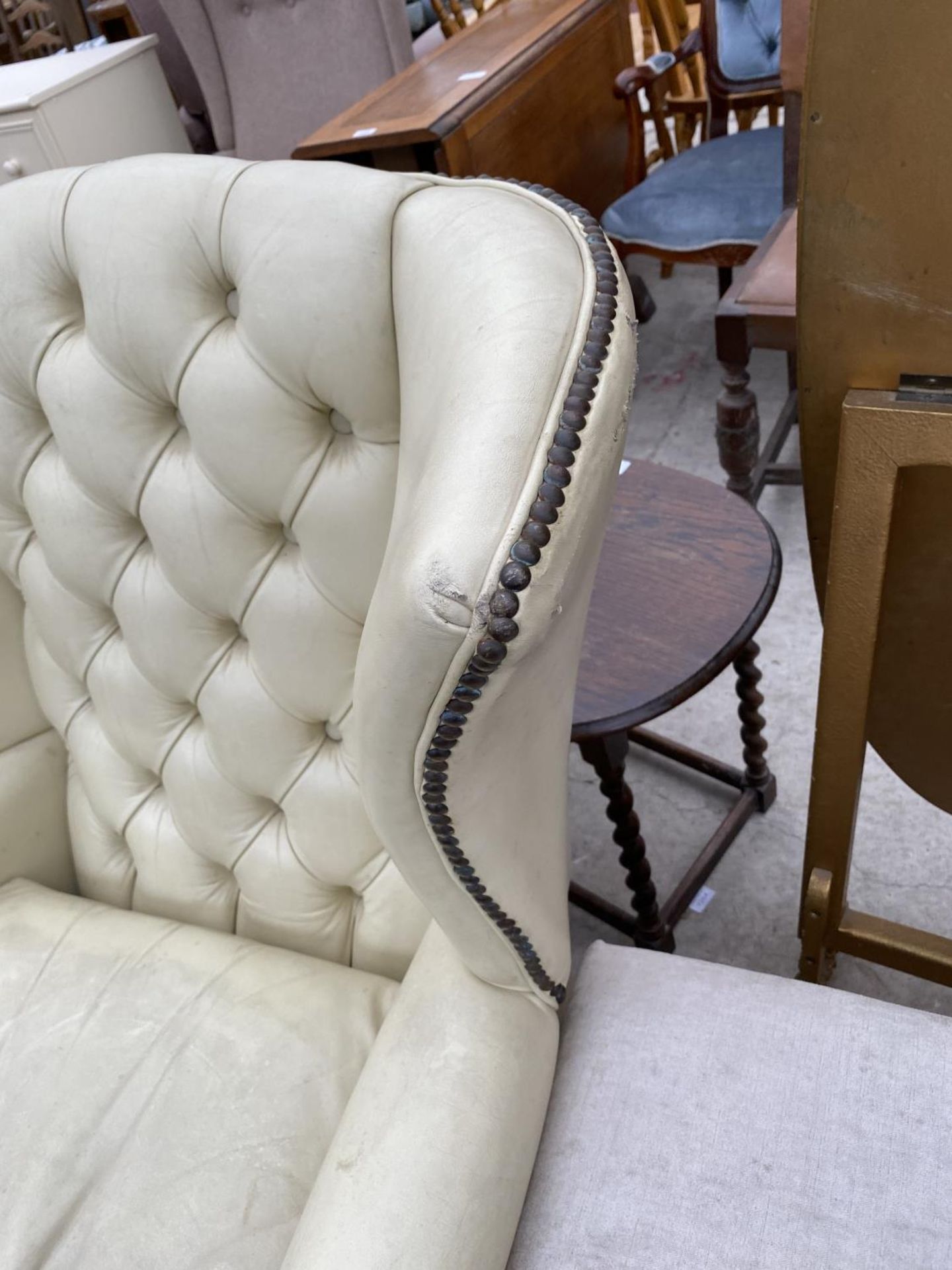 A STUDDED CREAM LEATHER WING AND BUTTON BACK ARMCHAIR - Image 3 of 4