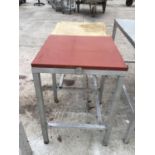 A WOODEN BUTCHERS BLOCK AND TABLE ON A METAL STAND