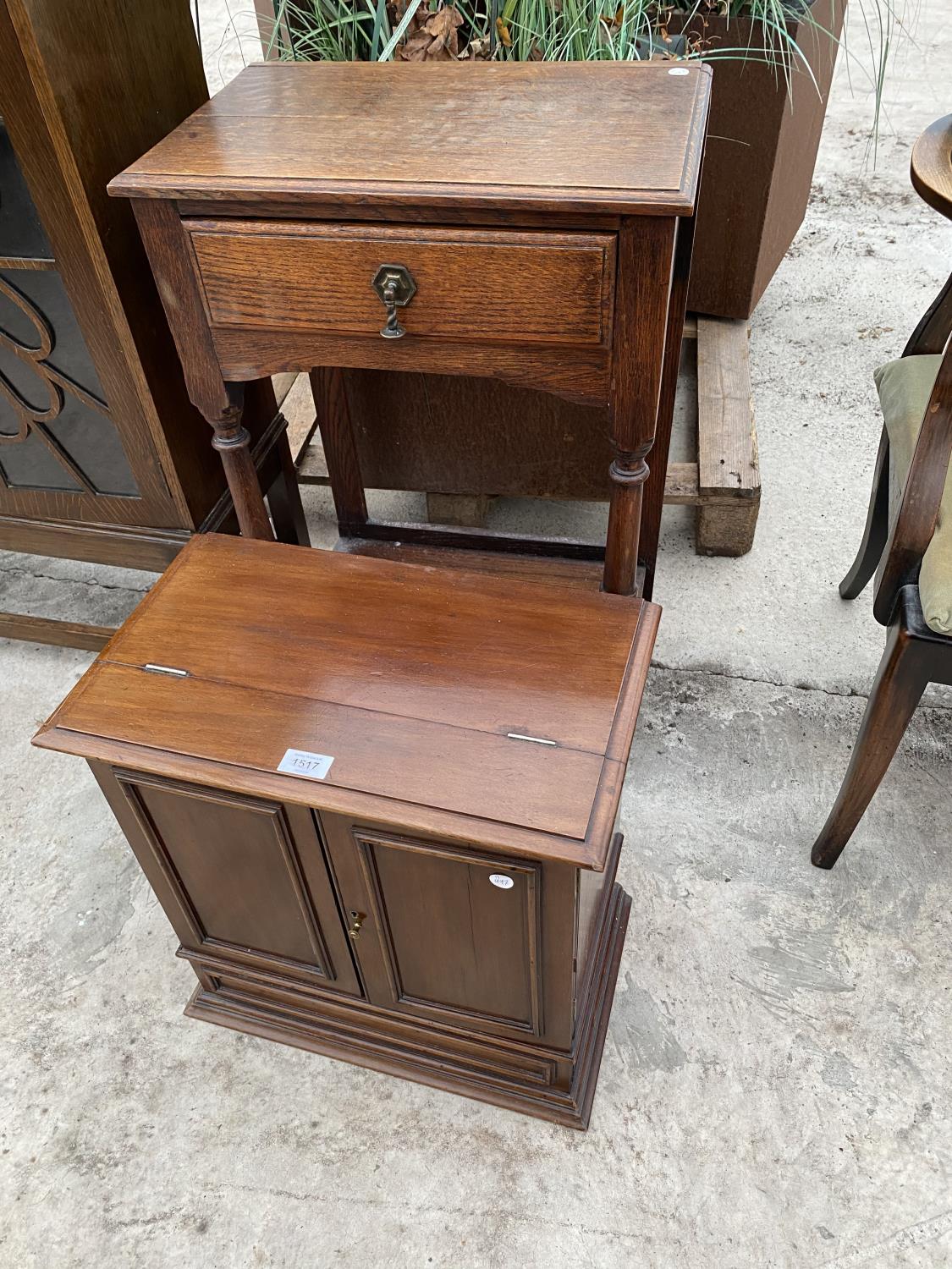 A SMALL MAHOGANY CABINET WITH TWO DOORS AND HINGED TOP AND A SMALL OAK HALL TABLE WITH SINGLE DRAWER