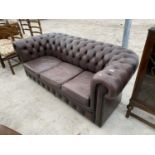 A BROWN LEATHER LOW BUTTON BACK CHESTERFIELD THREE SEATER SOFA
