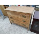 AN OAK CHEST OF THREE DRAWERS