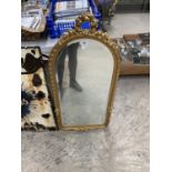 AN ORNATE GOLD PAINTED OVAL MIRROR
