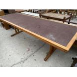 A LONG TEAK DINING TABLE