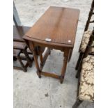 AN OAK DROP LEAF DINING TABLE