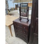 AN OAK CHEST OF FOUR DRAWERS AND AN OAK DRESSING TABLE MIRROR