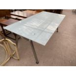 A DINING TABLE WITH OPAQUE GLASS TOP AND METAL SUPPORTS