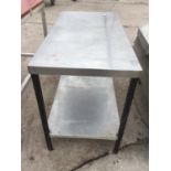 A STAINLESS STEEL TABLE WITH LOWER SHELF