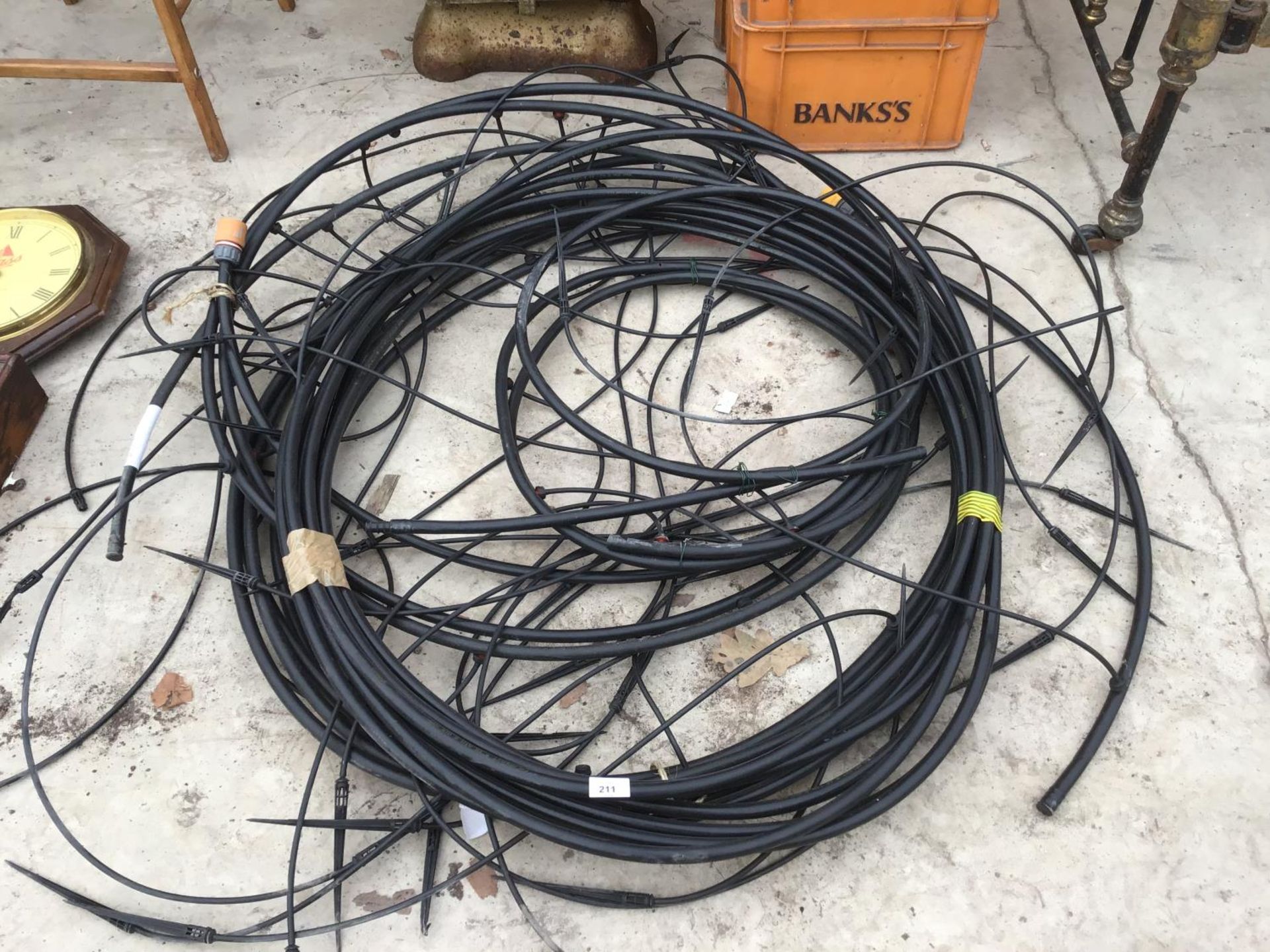 A LARGE QUANTITY OF PLASTIC IRRIGATION PIPING FOR WATERING HANGING BASKETS AND TUBS