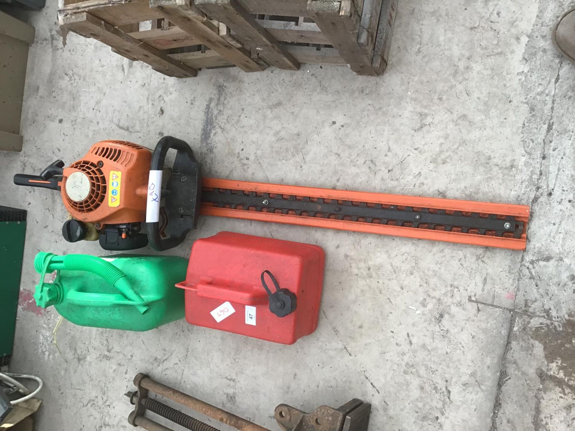 A STIHL HS 45 PETROL HEDGE TRIMMER AND TWO PETROL CANS