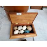 A WOODEN BOX OF AGATE AND FURTHER EGG STONES