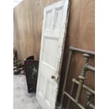 A VINTAGE WOODEN DOOR WITH ORIGINAL HANDLE AND AN ORNATE DOOR PLATE 76CM X 205CM