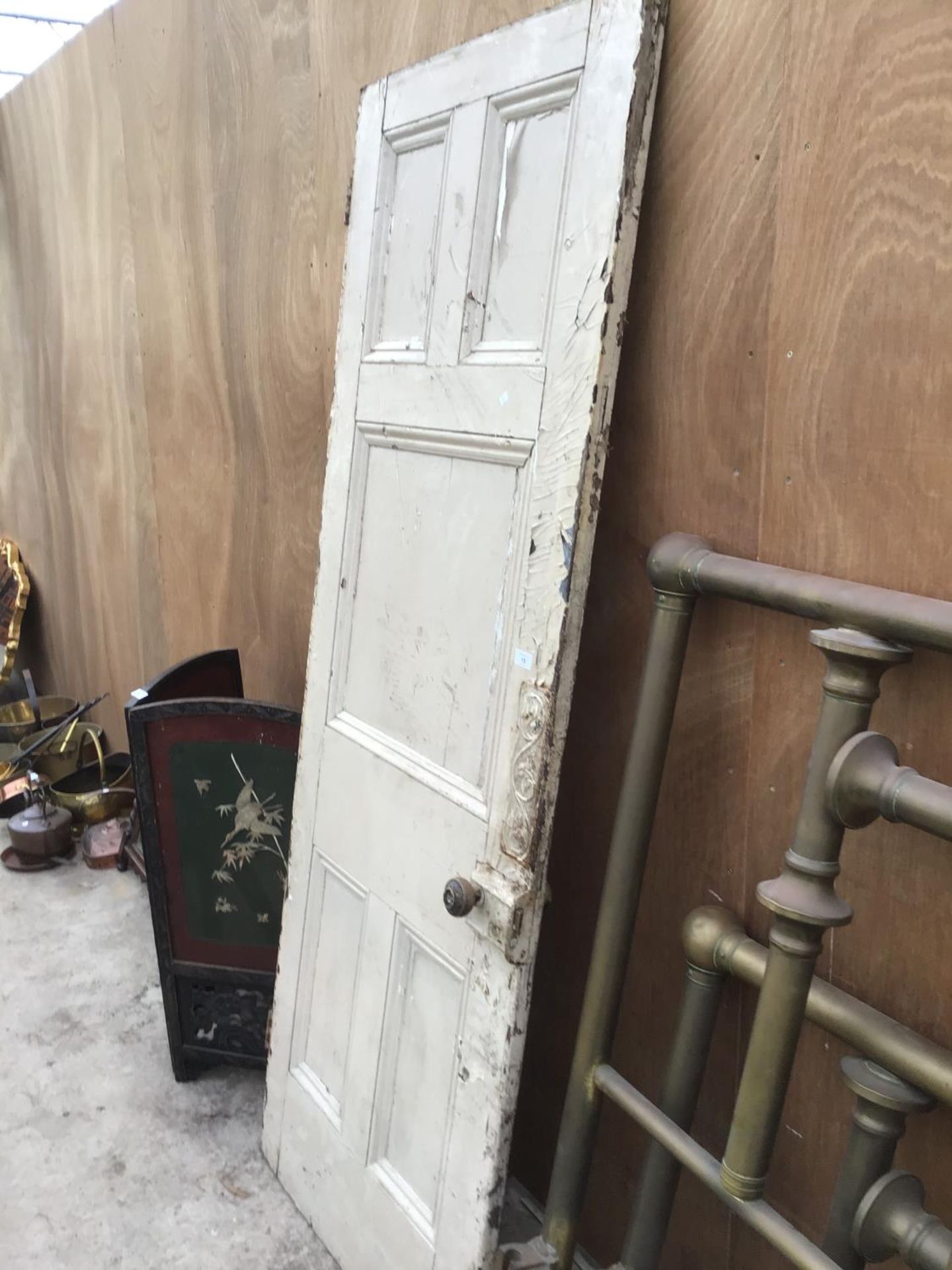 A VINTAGE WOODEN DOOR WITH ORIGINAL HANDLE AND AN ORNATE DOOR PLATE 76CM X 205CM