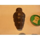 A CAST IRON GRENADE AND A TIN OF .22 PELLETS