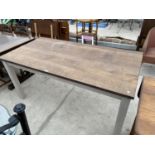 AN OAK DINING TABLE ON PAINTED SUPPORTS