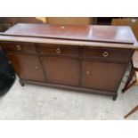 A STAG MINSTREL MAHOGANY SIDEBOARD WITH THREE DOORS AND THREE DRAWERS (REQUIRES REPAIR)