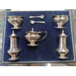 A CASED HALLMARKED SILVER CONDIMENT SET WITH TWO SPOONS, MUSTARD POT, TWO OPEN SALTS AND TWO