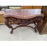 A HEAVILY CARVED MAHOGANY HALL TABLE