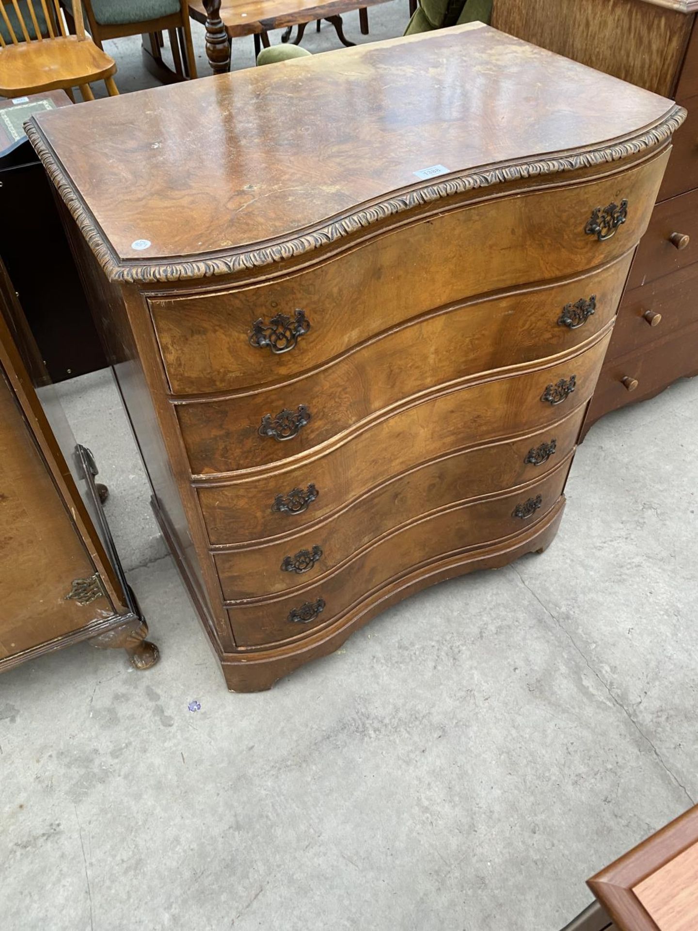 A WALNUT SERPENTINE FRONT CHEST OF FIVE DRAWERS