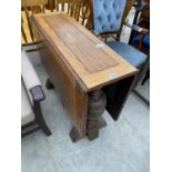 AN OAK DROP LEAF DINING TABLE