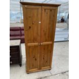 A PINE WARDROBE WITH TWO DOORS