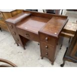 AN ART DECO STYLE MAHOGANY KNEE HOLE DESK WITH SEVEN DRAWERS