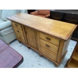 A PINE SIDEBOARD WITH ONE DOOR AND SIX DRAWERS