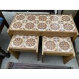 A TILE TOP NEST OF THREE TABLES