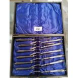 A VINTAGE CASED KNIFE AND FORK SET WITH HALLMARKED SILVER HANDLES