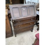 A PRIORY STYLE OAK BUREAU WITH FALL FRONT AND THREE DRAWERS