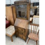 AN OAK BUREAU BOOKCASE WITH FALL FRONT, THREE DRAWERS AND UPPER LEAD GLAZED DOOR