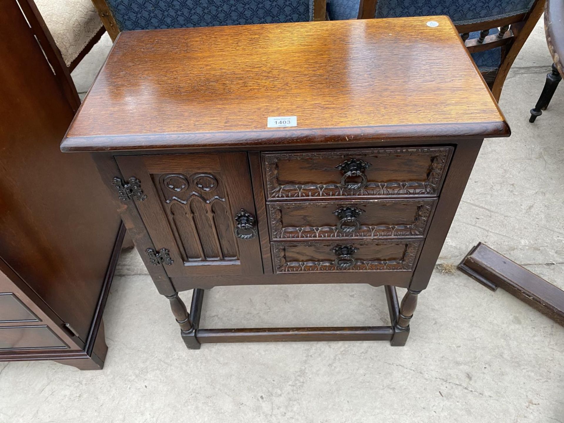 A SMALL JAYCEE OAK CABINET WITH ONE DOOR AND TWO DRAWERS