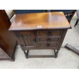 A SMALL JAYCEE OAK CABINET WITH ONE DOOR AND TWO DRAWERS