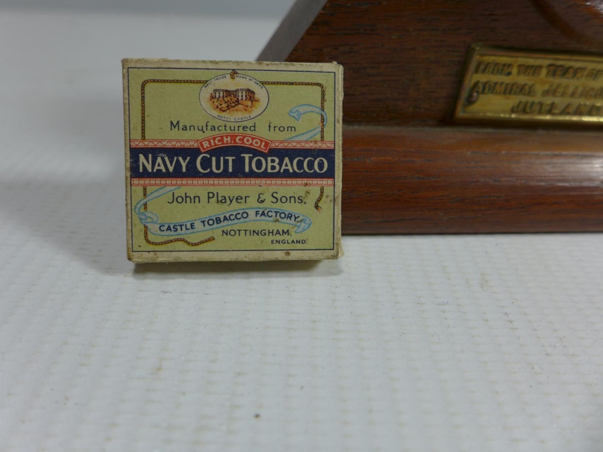 A WATCH HOLDER FROM THE TEAK OF H.M.S IRON DUKE AND A MINIATURE PLAYERS CIGARETTE PACKET - Image 2 of 2