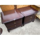 TWO STAG MINSTREL MAHOGANY BEDSIDE CABINETS EACH WITH TWO DRAWERS AND DRESSING SLIDE