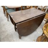 AN OAK DROP LEAF DINING TABLE