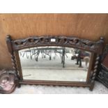 A HEAVILY CARVED OAK FRAMED MIRROR WITH BARLEY TWIST SIDES