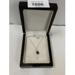 A BOXED 9CT GOLD NECKLACE WITH A PURPLE JEWEL PENDANT