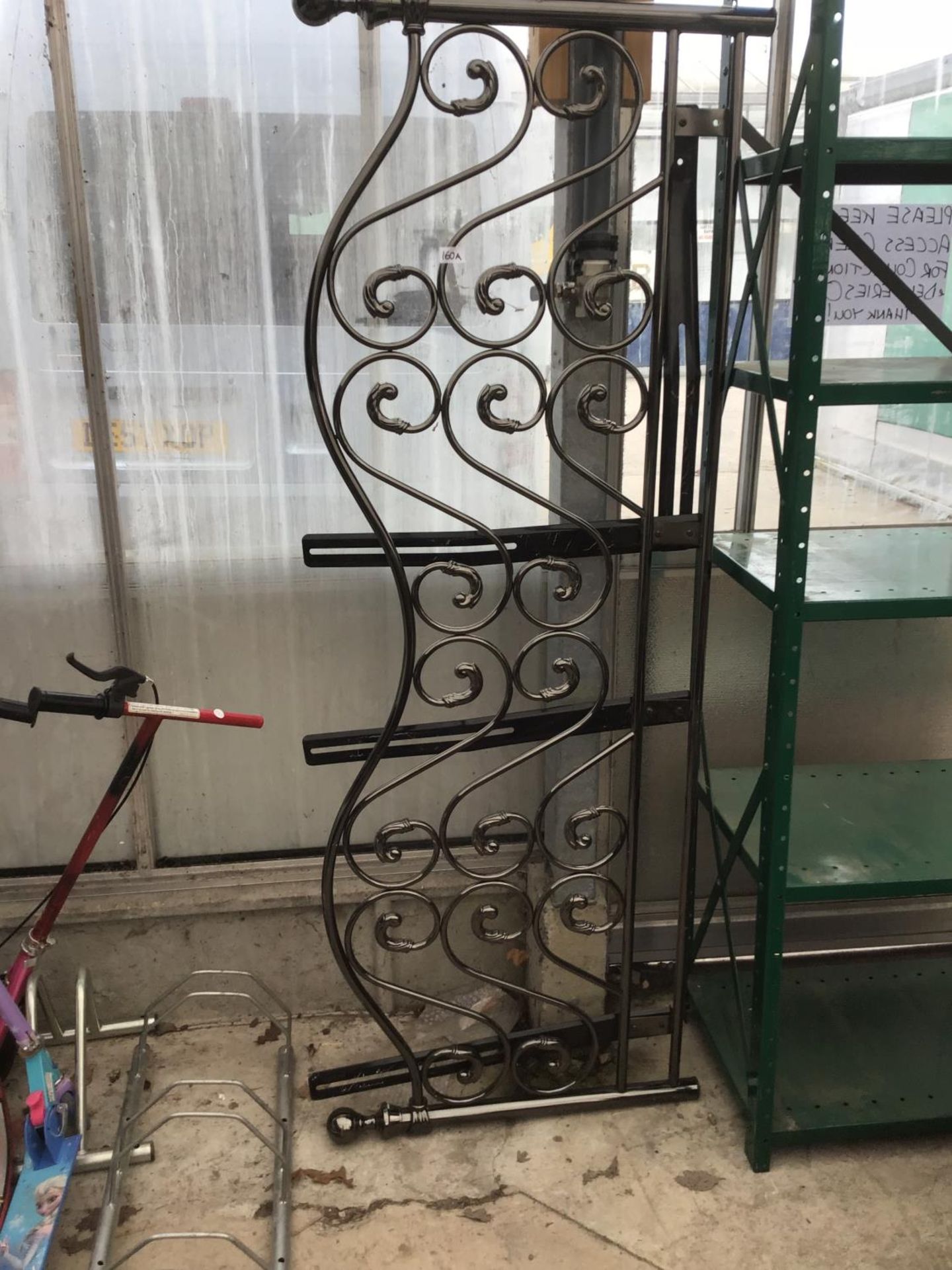 AN ORNATE METAL SIX FOOT HEADBOARD