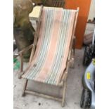 A VINTAGE WOODEN DECKCHAIR WITH ORIGINAL STRIPED CANVAS