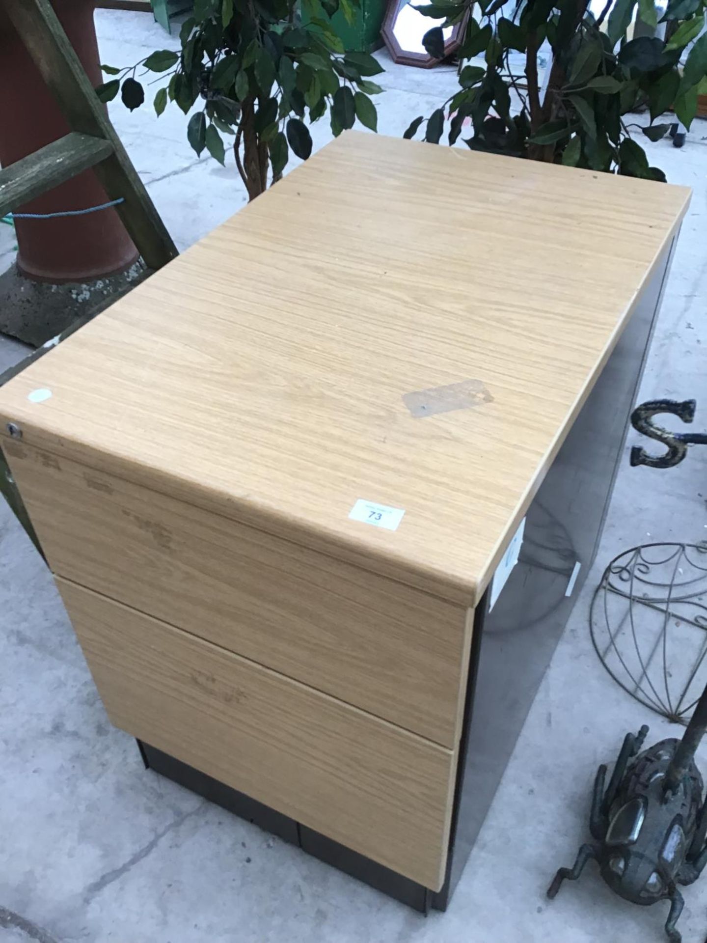 A FILING CABINET AND A METAL LADDER