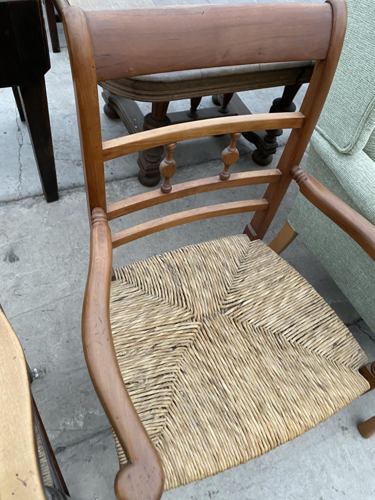 TWO LADDER BACK CARVER DINING CHAIRS WITH RUSH SEATS - ONE OAK, ONE MAHOGANY - Image 4 of 5