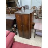 A SMALL MAHOGANY CABINET WITH TWO DOORS