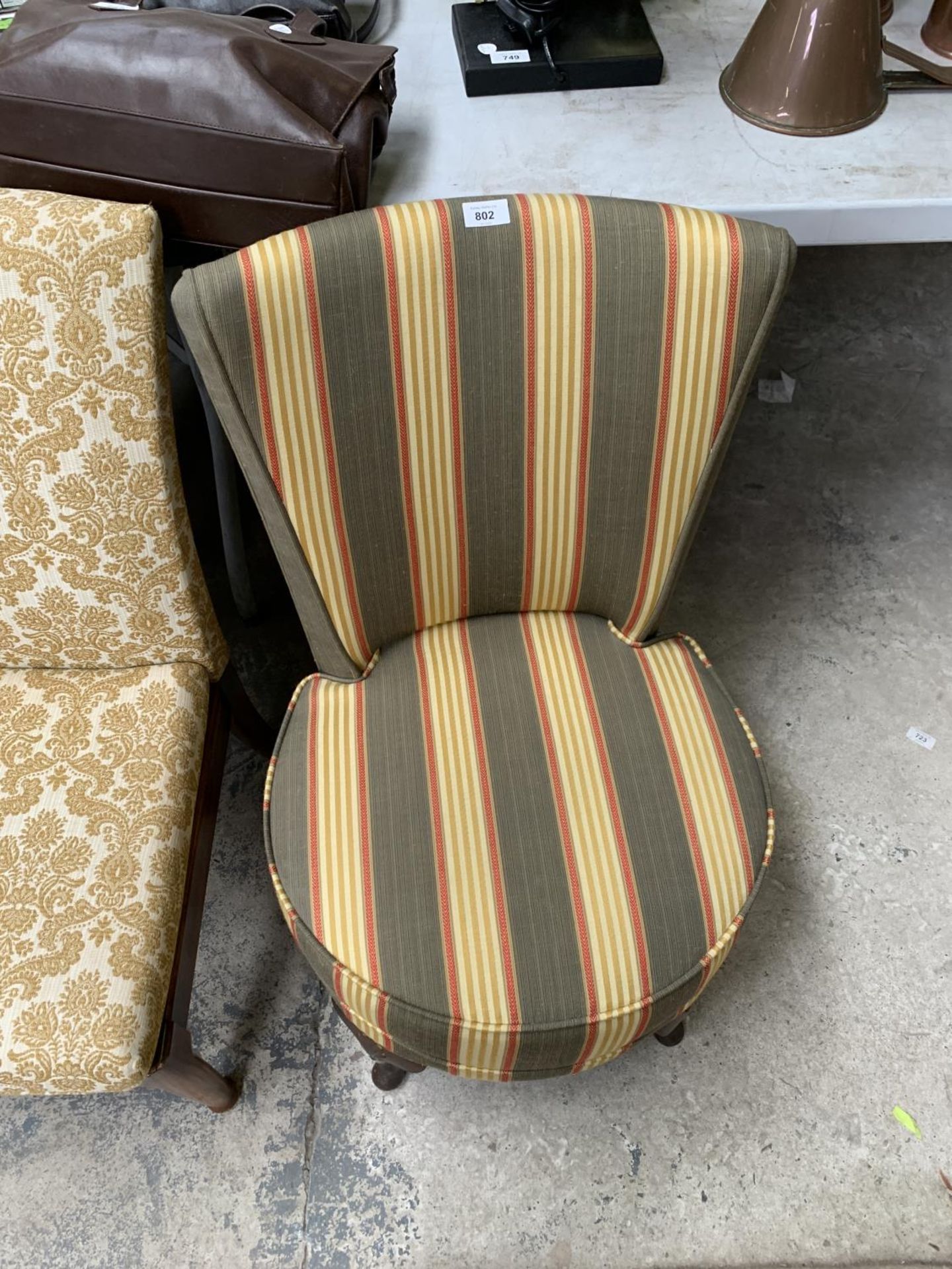 A STRIPED UPHOLSTER BEDROOM CHAIR