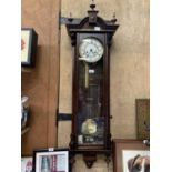 A LARGE MAHOGANY CASED CHIMING WALL CLOCK