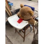 A WOODEN HIGH CHAIR WITH A TEDDY