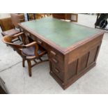 AN OAK PARTNER'S DESK WITH SEVEN DRAWERS AND GREEN LEATHER WRITING SURFACE AND A MAHOGANY CAPTAIN'