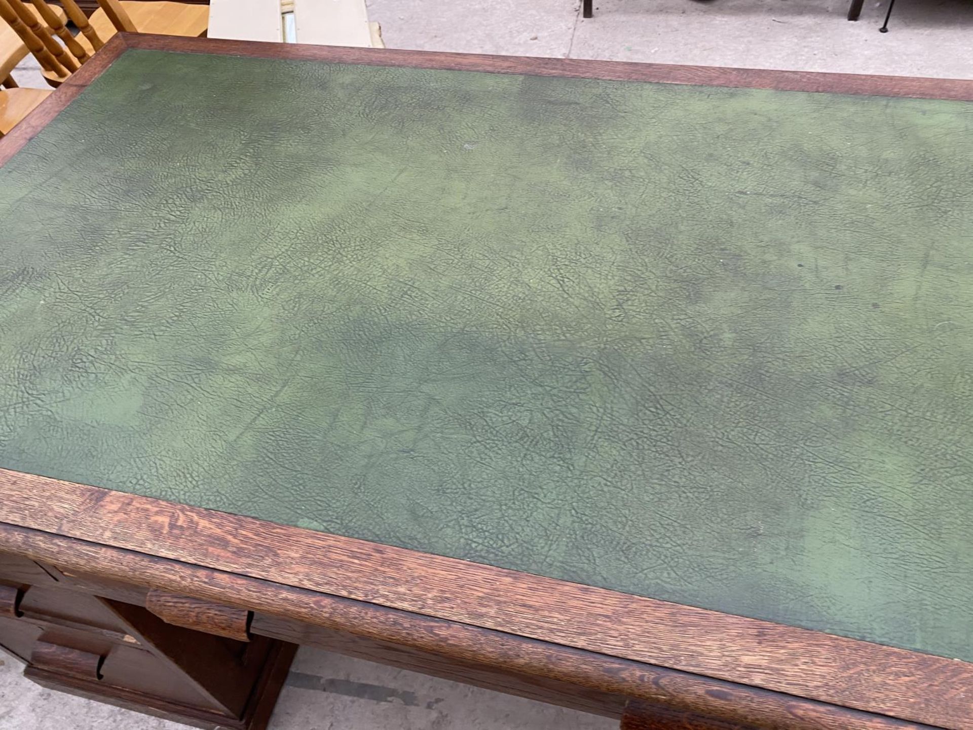 AN OAK PARTNER'S DESK WITH SEVEN DRAWERS AND GREEN LEATHER WRITING SURFACE AND A MAHOGANY CAPTAIN' - Image 2 of 8