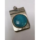 A WHITE METAL LOCKET WITH RUSKIN TYPE BLUE STONE